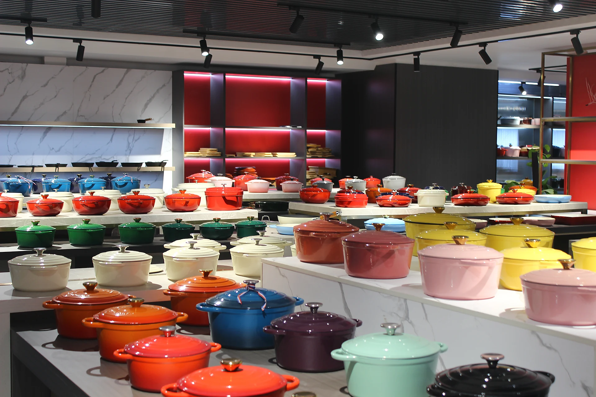 Colorful enameled cast iron Dutch oven and cookware display for set planning